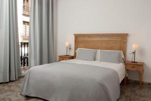 Llit o llits en una habitació de Hostal Portofino