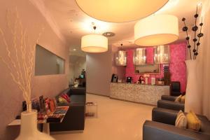 a lobby with couches and a bar in the background at Friday Hotel in Prague