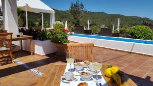 a table with food on top of a patio at Hotel Rural Can Maries in Puerto de San Miguel