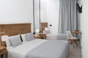 Llit o llits en una habitació de Hostal Portofino