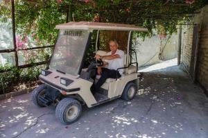 a man is driving a golf cart at Hotel Angelino in Ischia