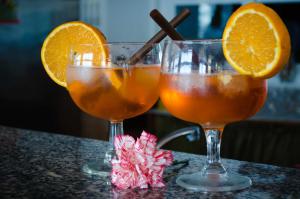 two glasses of orange juice sitting on a table at Hotel Angelino in Ischia