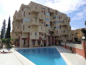 a building with a swimming pool in front of a building at Buenavista Apartment in Sitges