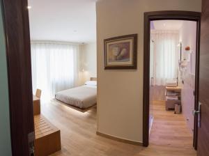 a room with a bedroom with a bed and a mirror at Casa di Lucia in Chioggia