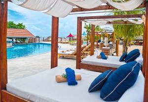 two beds in a resort with a swimming pool at Sandals Ochi Beach All Inclusive Resort - Couples Only in Ocho Rios