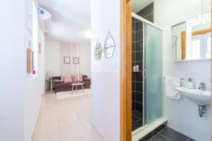 a bathroom with a glass shower and a sink at Fora Apartments in Dubrovnik +43 photos
