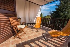 two chairs and a hammock on a patio at P & P Nyaraló in Szigliget