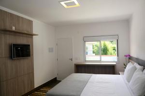 a bedroom with a large bed and a window at Hotel Bertell Inn in Penedo