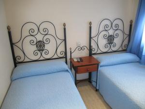 Ένα ή περισσότερα κρεβάτια σε δωμάτιο στο Hostal El Gaitero