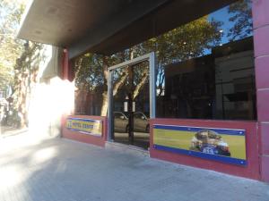 a pink building with a sign in front of a window at Hotel Central in Durazno