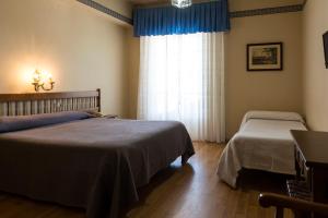 Postel nebo postele na pokoji v ubytování Hotel El Molino