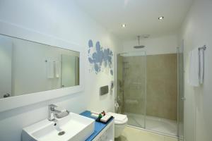 a bathroom with a sink and a toilet and a shower at Costa Luvi Hotel Bodrum - All Inclusive in Gümbet
