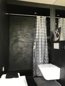 a black bathroom with a sink and a shower at Le studio Florent in Lannion +11 photos