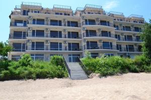 a tall building on the beach with stairs in front at Villa Maria 2 in Chernomorets