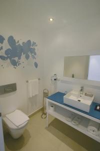 a bathroom with a toilet and a sink and a mirror at Costa Luvi Hotel Bodrum - All Inclusive in Gümbet