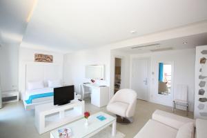 a white living room with a bed and a couch at Costa Luvi Hotel Bodrum - All Inclusive in Gümbet