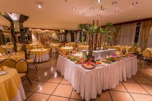a long table with plates of food on it in a restaurant at Hotel Astor in Mar del Plata