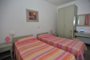 Voodi või voodid majutusasutuse Albergo Dei 10 Colori toas