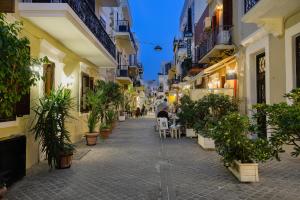 a street in a town with potted plants at Aeria Apartments in Chania Town
