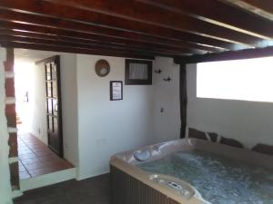 a bathroom with a tub in the middle of a room at Casa Rural "La Molina" in Máguez