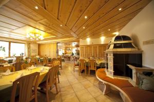 a restaurant with tables and chairs and a fireplace at Landgasthof Paradies in Frickingen