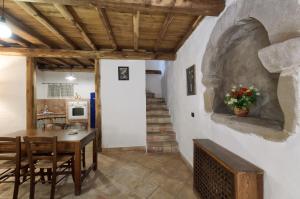 a kitchen and dining room with a table and chairs at Forza d'Agrò Holiday Home in Forza dʼAgro