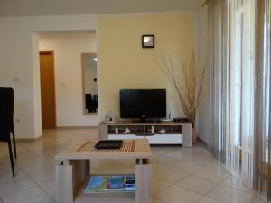 a living room with a tv and a table at Kuća Renata in Pula
