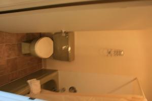 a bathroom with a tub and a sink and a mirror at Portland Value Inn & Suites in Portland +9 photos