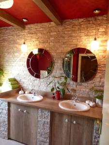 a bathroom with two sinks and three mirrors at Villa Tropica, total privacy, tropical garden and private pool in Kaštela