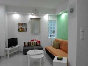 a living room with a couch and a table at Aristotelous Square Luxury Apartment in Thessaloniki
