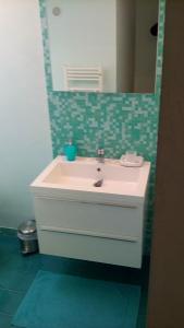 een badkamer met een witte wastafel en een spiegel bij Casa Vacanze Gaia in Assisi