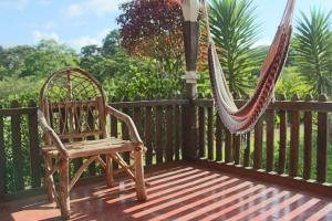 a hammock and a chair on a porch at Finca Lindos Ojos in Estelí