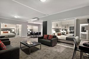 a living room with a couch and a bed at Quest Campbelltown in Campbelltown
