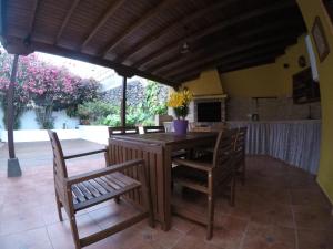 a wooden table and chairs on a patio at Bajamar 152 in Bajamar