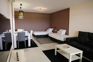 a living room with a couch and a table at RochaBay Apartment in Portimão