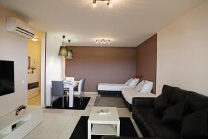 a living room with a couch and a table at RochaBay Apartment in Portimão