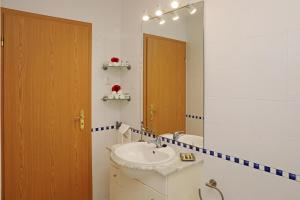 a bathroom with a sink and a mirror at RochaBay Apartment in Portimão +43 photos