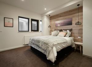 a bedroom with a large bed and two windows at Alto Villa 304 in Mount Buller
