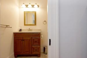 uma casa de banho com um lavatório e um espelho em Cheltenham Suites em Caledon