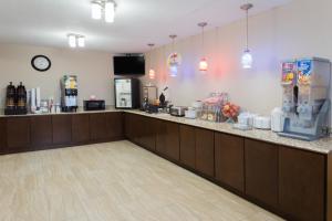 a restaurant with a counter with a cash register at Super 8 by Wyndham Janesville in Janesville