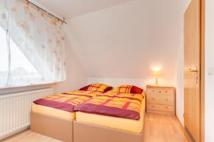 Een bed of bedden in een kamer bij Pension vorm Darß