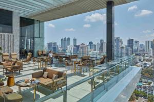 a balcony with furniture and a view of a city at 137 Pillars Residences Bangkok in Bangkok