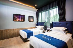 Postel nebo postele na pokoji v ubytování Manhattan Business Hotel TTDI