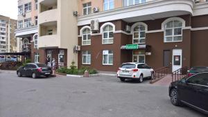 two cars parked in a parking lot in front of a building at KashEmir in Kyiv