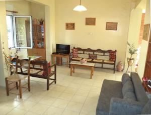 a living room with a couch and a table at Poseidon Hotel in Heraklio