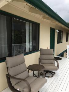 two chairs and a table on a porch at Ahi Hale in Kailua-Kona