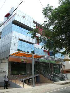 a man standing in front of a building at Saaral Residency in Chennai