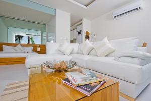 a living room with a white couch and a coffee table at Chi Samui Resort in Bophut