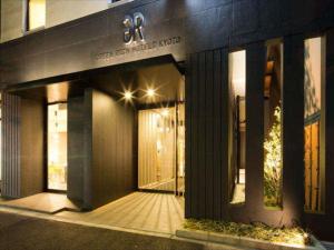 a building with an entrance to a store at night at Green Rich Hotel Kyoto Station South (Artificial hot spring Futamata Yunohana) in Kyoto