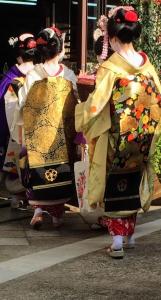 three women in kimonos walking down the street at International Guest House Tani House in Kyoto
